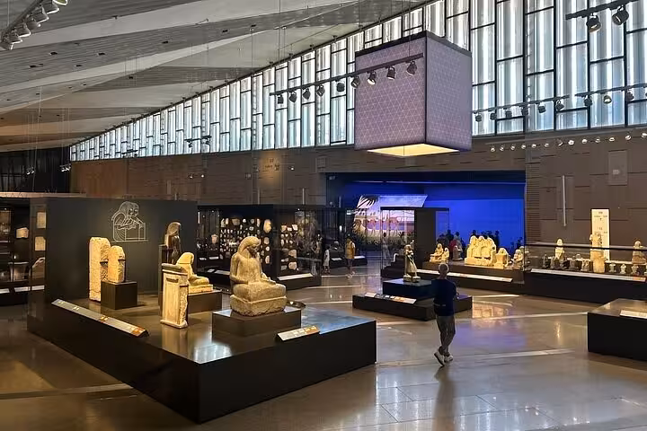 Grand Egyptian Museum main gallery with ancient statues, perfect for half-day Cairo tour with lunch and tickets