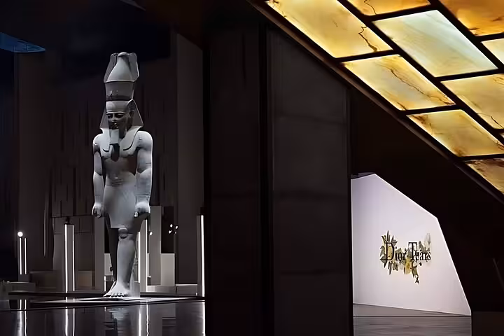 Ancient Egyptian pharaoh statue at Grand Egyptian Museum Cairo gallery, QR ticket admission with transfer optional