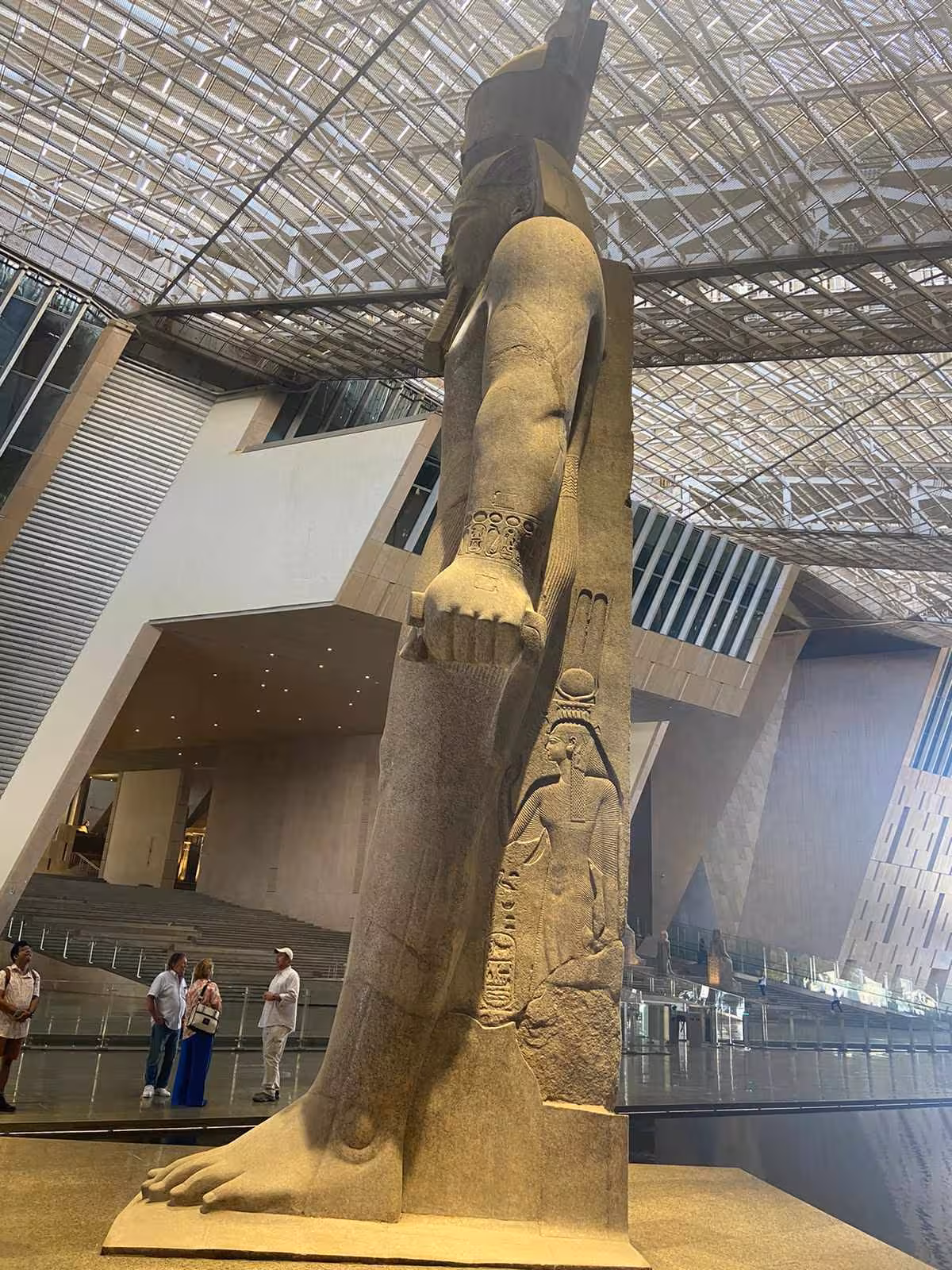 Colossal pharaoh statue inside the Grand Egyptian Museum Cairo, highlight of full-day Giza Pyramids tour with lunch