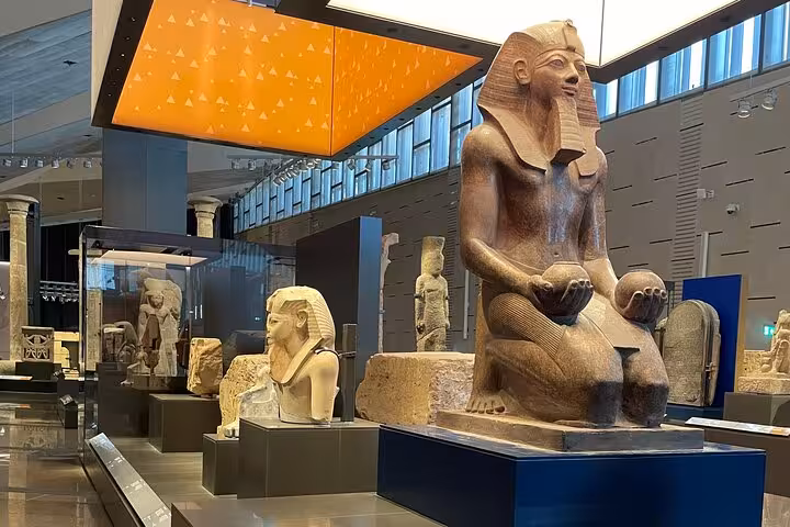Grand Egyptian Museum gallery with colossal pharaoh statue, highlight of Cairo and Giza private tour