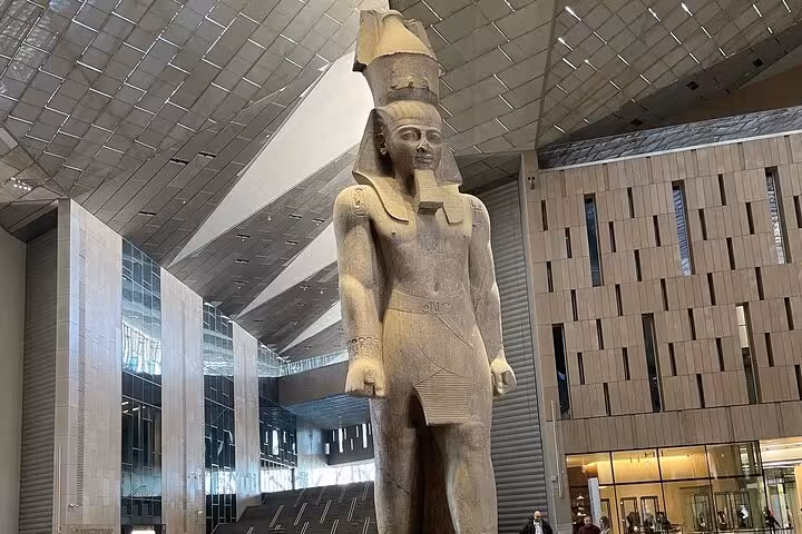 Grand Egyptian Museum interior with towering pharaoh statue, highlight of private Cairo tour with lunch