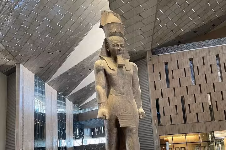 Colossal pharaoh statue inside Grand Egyptian Museum Giza on private tour with Saqqara, Memphis and lunch