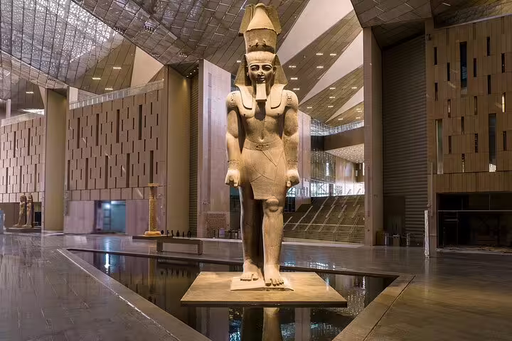 Grand Egyptian Museum interior with colossal pharaoh statue, included on Ain Sokhna Port tour to Giza Pyramids