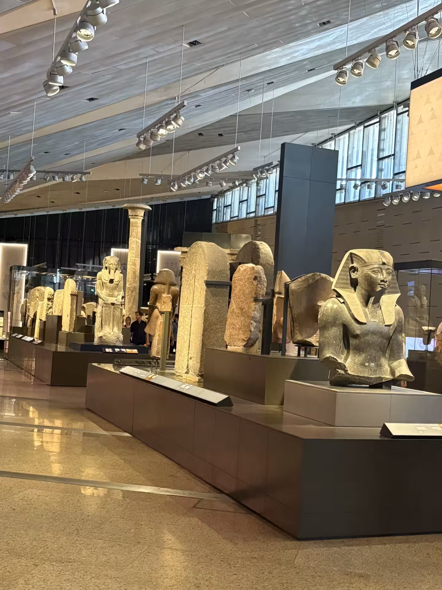 Grand Egyptian Museum gallery with colossal pharaoh statues on display, private all-inclusive Cairo tour