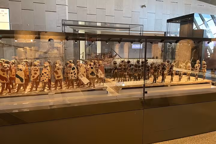Grand Egyptian Museum display of ancient Egyptian warrior figurines, highlight of Hurghada to Cairo tour