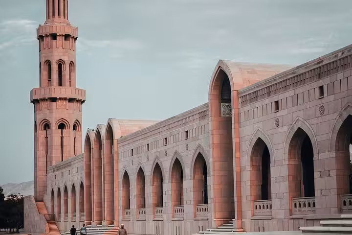 Grand Mosque minaret and arched facade on a private Muscat city tour visiting iconic landmarks in Oman