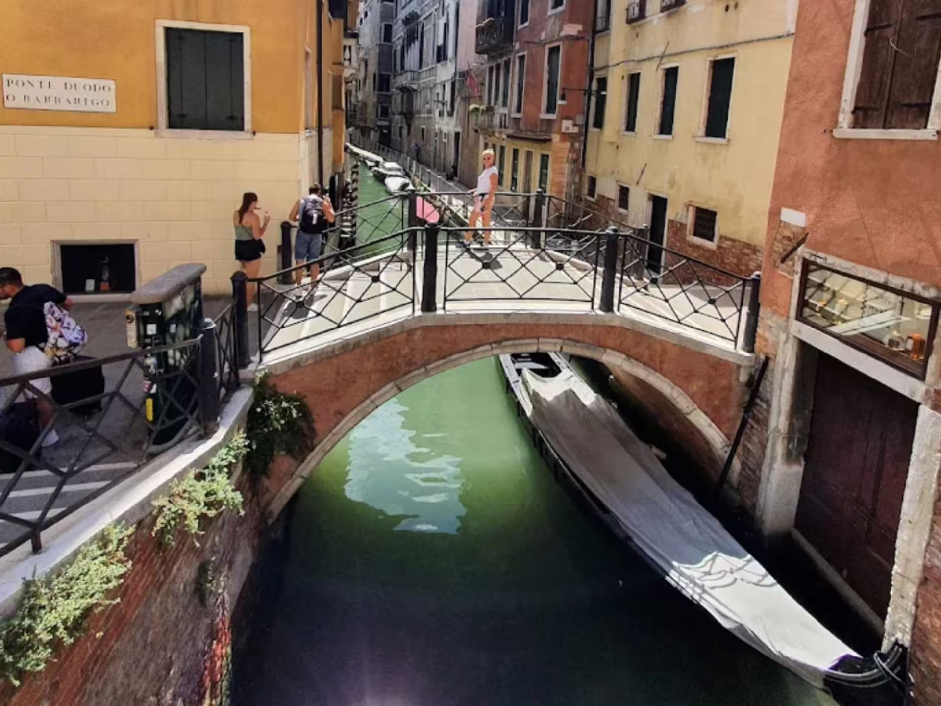 Scenic Venetian canal with picturesque bridge, ideal for a relaxing grappa tasting tour.