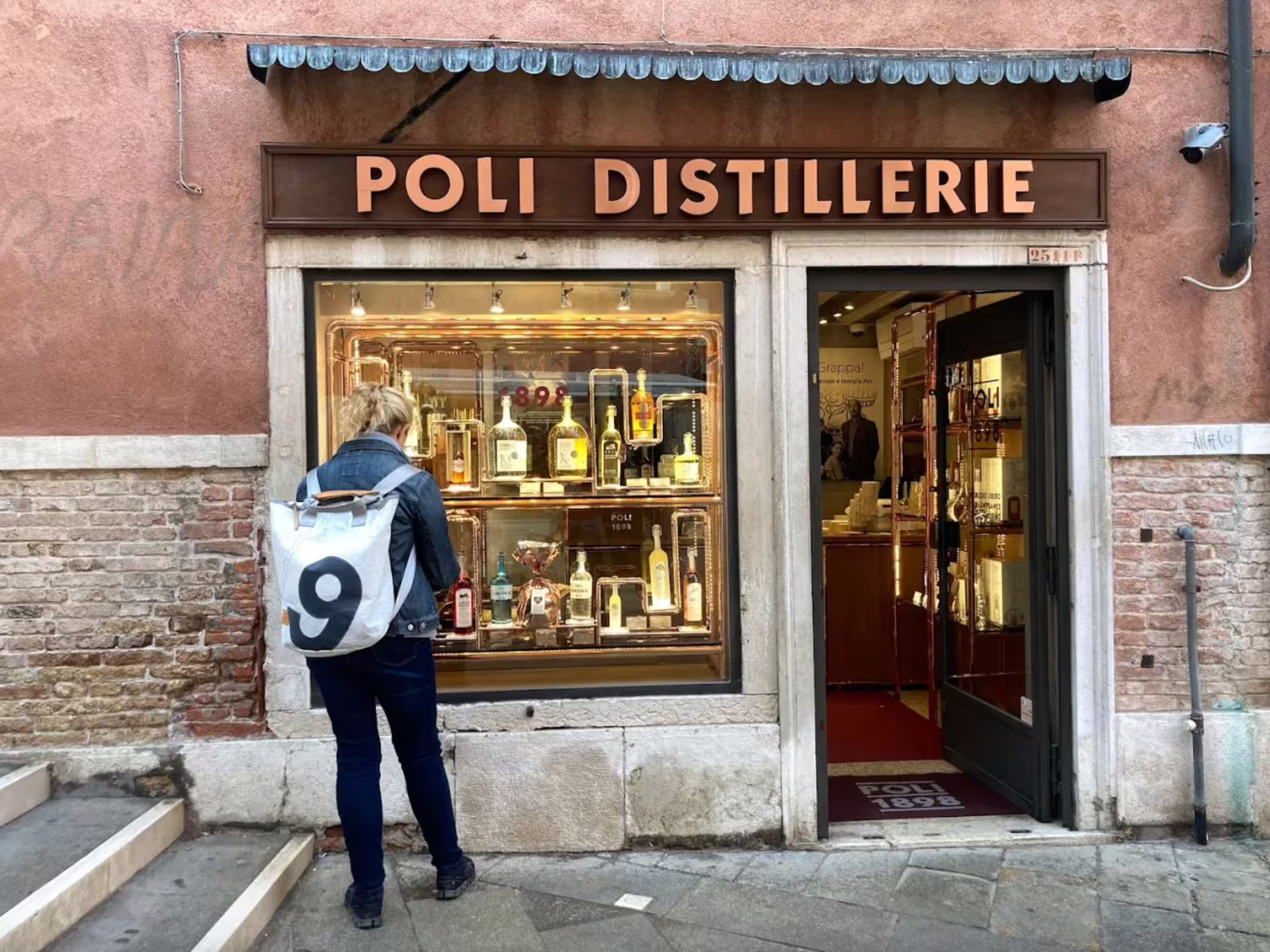 Traveler exploring Poli Distillerie in Venice for authentic grappa tasting experience.