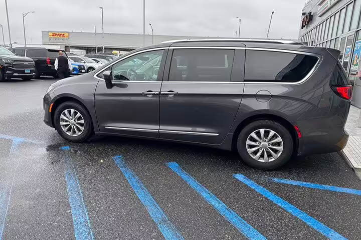Gray Chrysler Pacifica minivan parked at Long Beach Airport for private transfer service