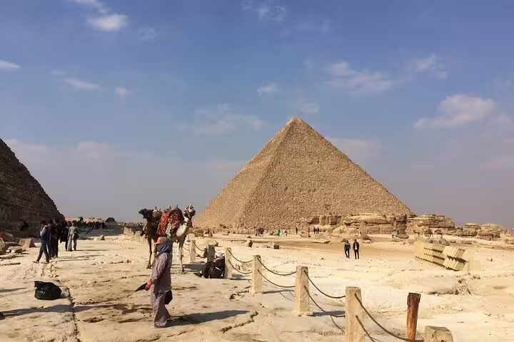 Great Pyramid of Giza with tourists and camel rides, highlight of Cairo pyramids and Memphis day tour