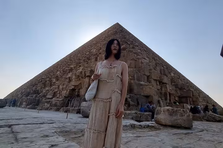 Visitor standing by the Great Pyramid of Giza during Cairo private tour, iconic ancient Egypt landmark