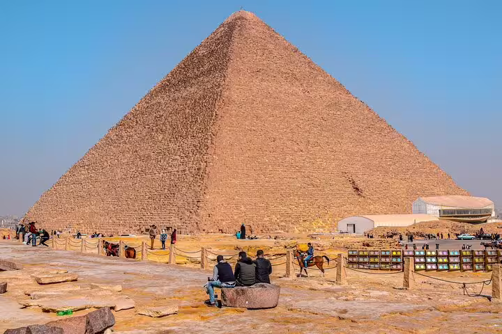 Close view of the Great Pyramid of Giza with visitors, part of a private pyramids and Egyptian Museum tour