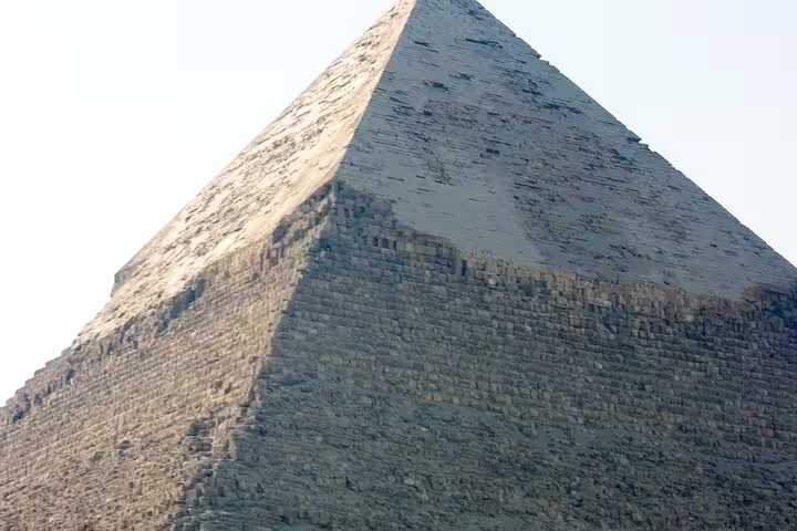 Close-up view of the Great Pyramid of Giza stone blocks under clear sky on a Cairo and Giza day tour
