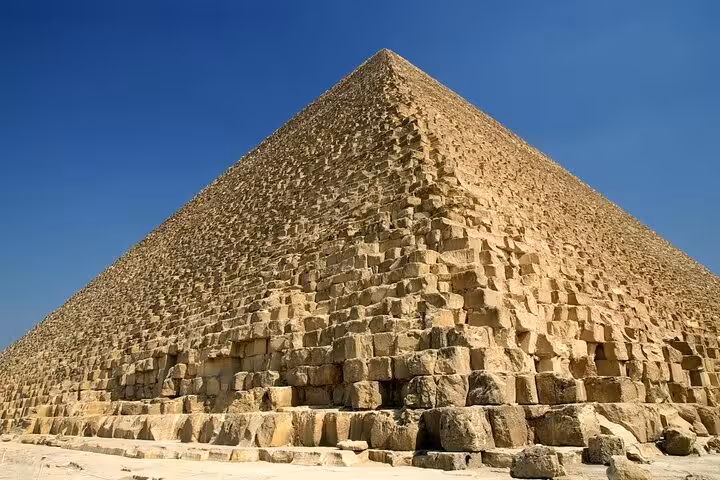 Close-up of the Great Pyramid of Giza stone blocks on a full-day guided bus tour from Sharm El Sheikh
