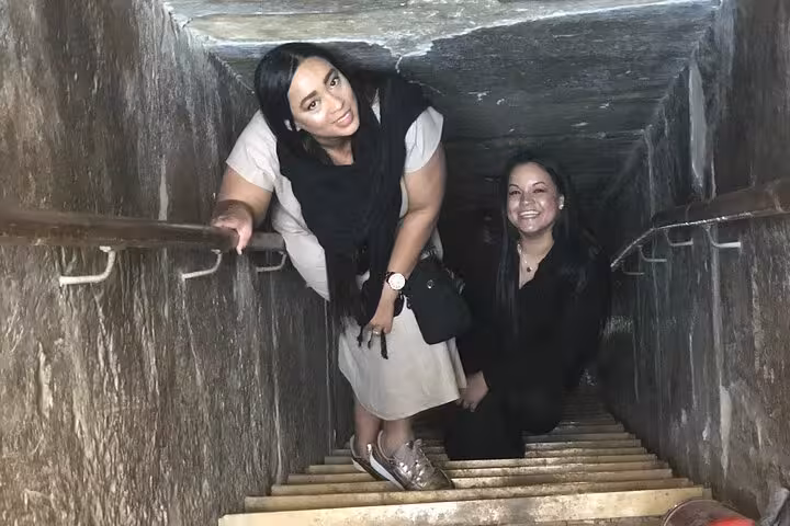 Tour guests climbing the Great Pyramid interior passage in Giza on a 3-day Cairo Giza Alexandria tour