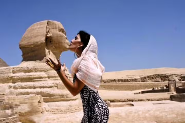 Visitor posing by the Great Sphinx at Giza on a private Alexandria Port shore excursion to Cairo and Grand Egyptian Museum