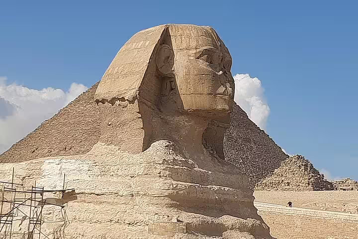 Close-up of the Great Sphinx with pyramid backdrop on private Giza tour, iconic Cairo landmark under blue sky