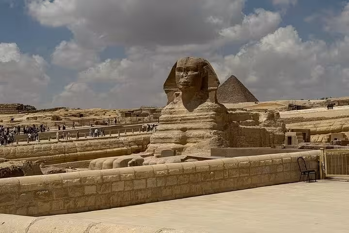 Wide view of the Great Sphinx and Giza pyramid under cloudy skies, Giza Pyramids tour ancient wonders Egypt