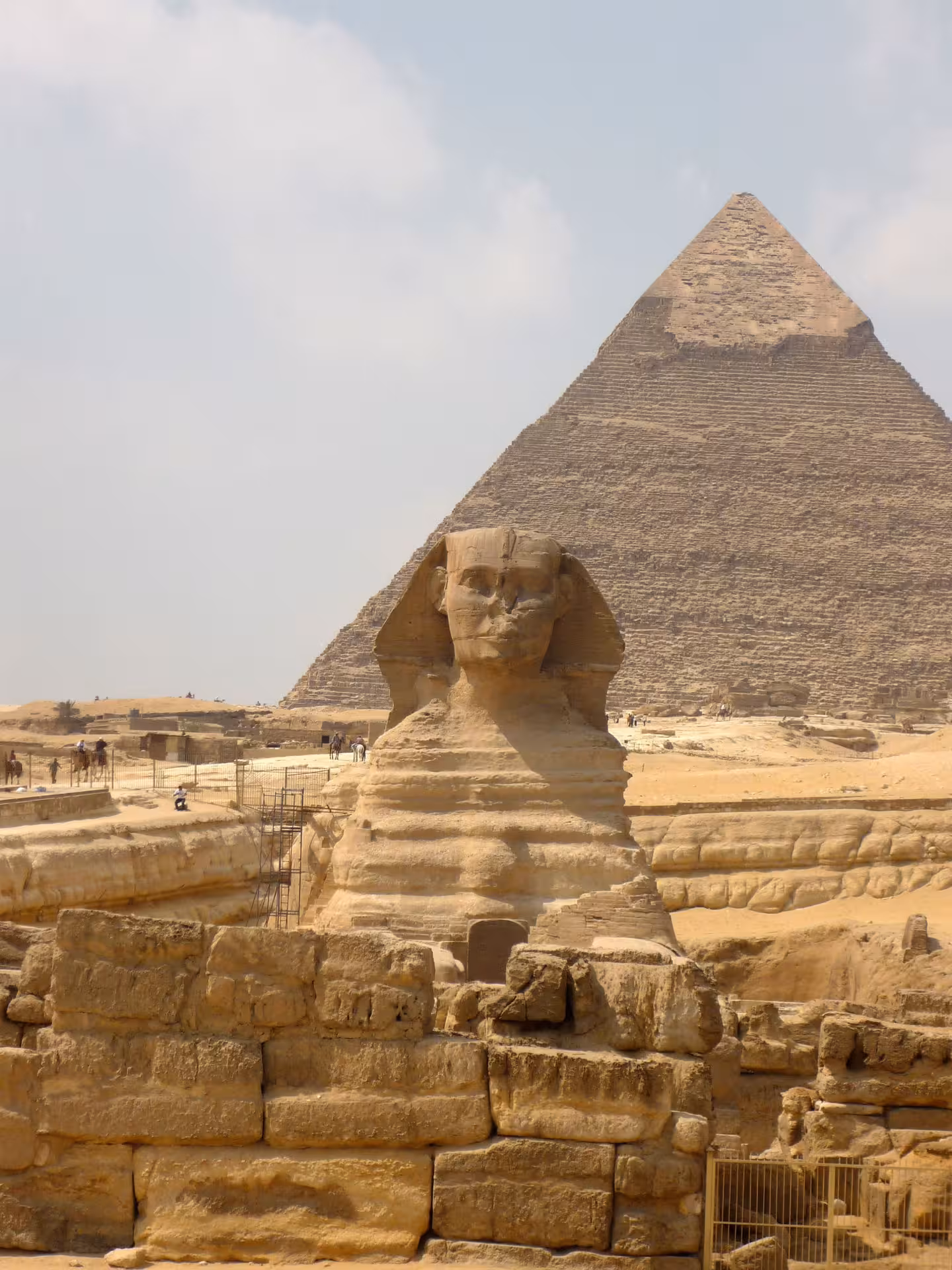 Great Sphinx of Giza with the Pyramid of Khafre rising behind it under a hazy sky