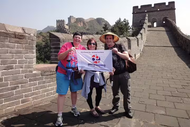 Tourists enjoying a sunny day on the Great Wall of China during a private 14-day China and Yangtze River tour.