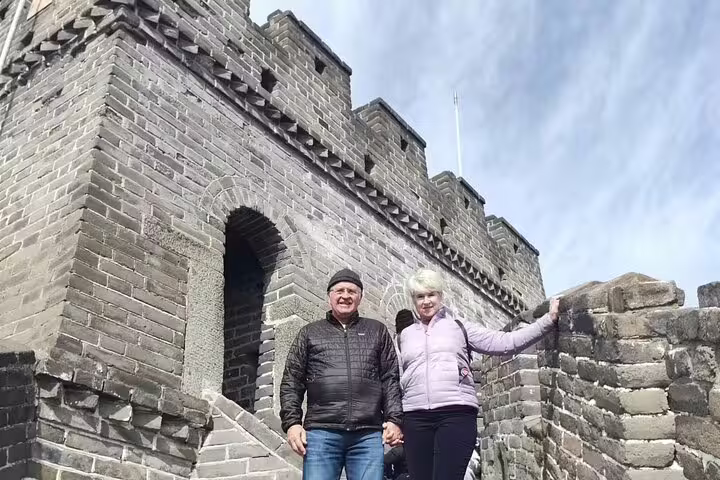 Tourists enjoying the scenic view of the Great Wall of China on the 14 Days Private Best China and Yangtze River Cruise Tour.
