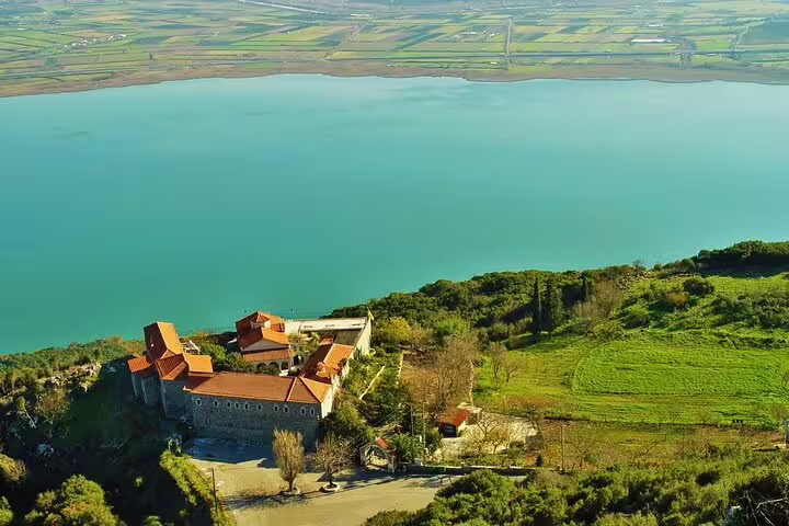 Lakeside monastery and farmland views on private Greece tour to Meteora, Oiniades, Ancient Plevrona and Delphi