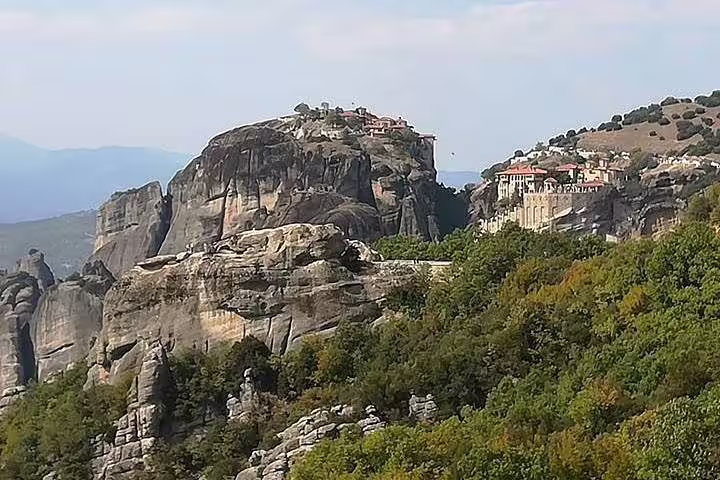 Meteora monasteries perched on dramatic rock cliffs, panoramic Greece landscape view on a private day trip