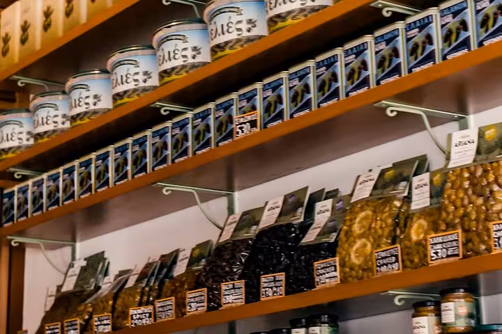 Greek deli shelves with olives and local specialties, tasting stop on the Small Group Athens Walk and Taste tour