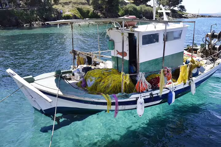 Traditional Greek fishing boat in crystal-clear Halkidiki waters, authentic coastal scene on private day trip from Thessaloniki