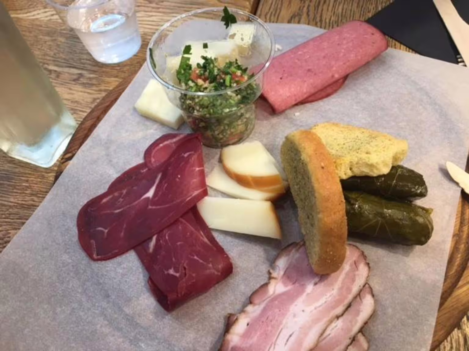 Greek meze platter on Athens food walking tour with cured meats, cheeses, dolmades, bread and salsa