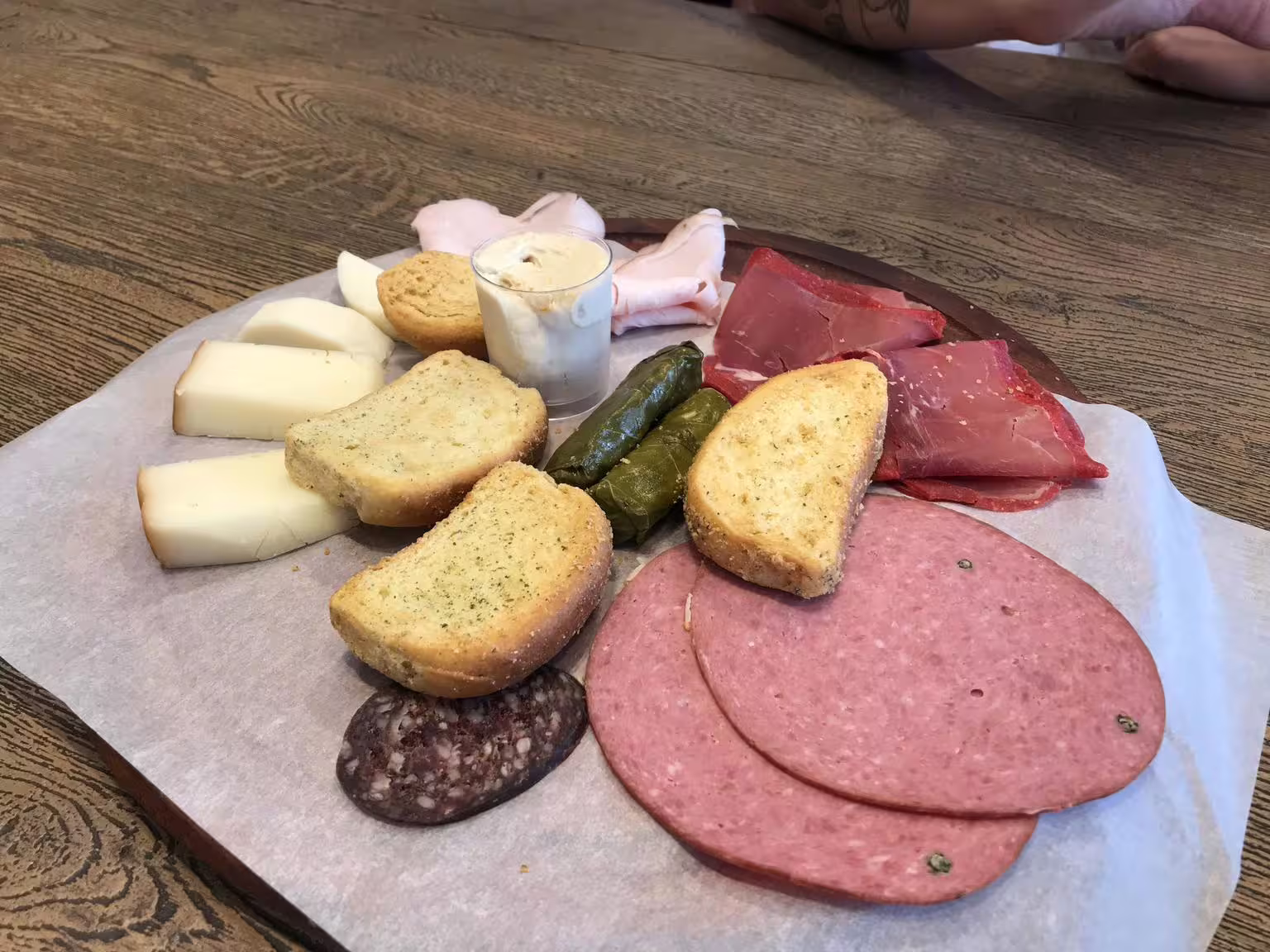 Greek mezze platter with local cheeses, cured meats, dolmades and rusks on a gourmet Athens walking tour