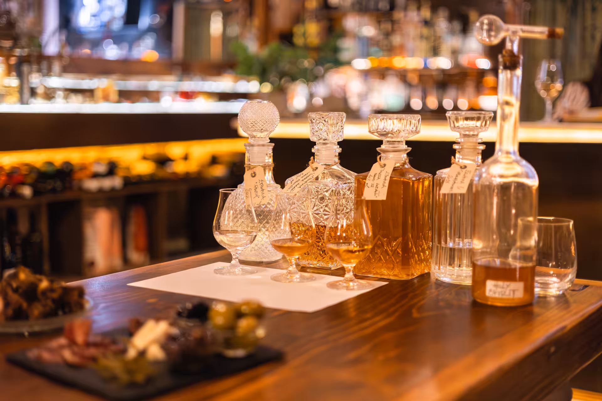 Greek spirits tasting with carafes and mezze at a bar on the Munch Around Naxos Town food tour