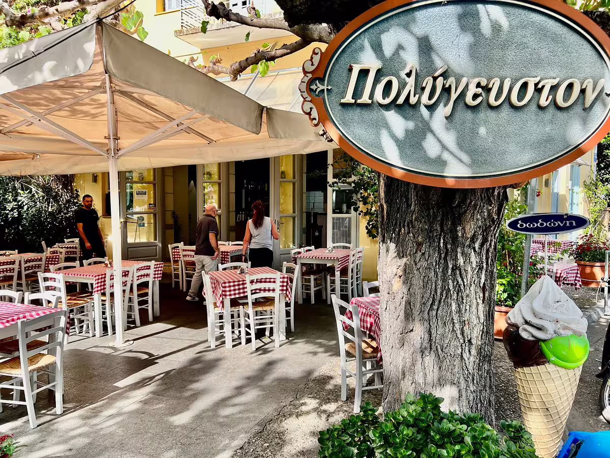 Traditional Greek taverna stop on private Ancient Olympia tour from Athens, shaded terrace with tables