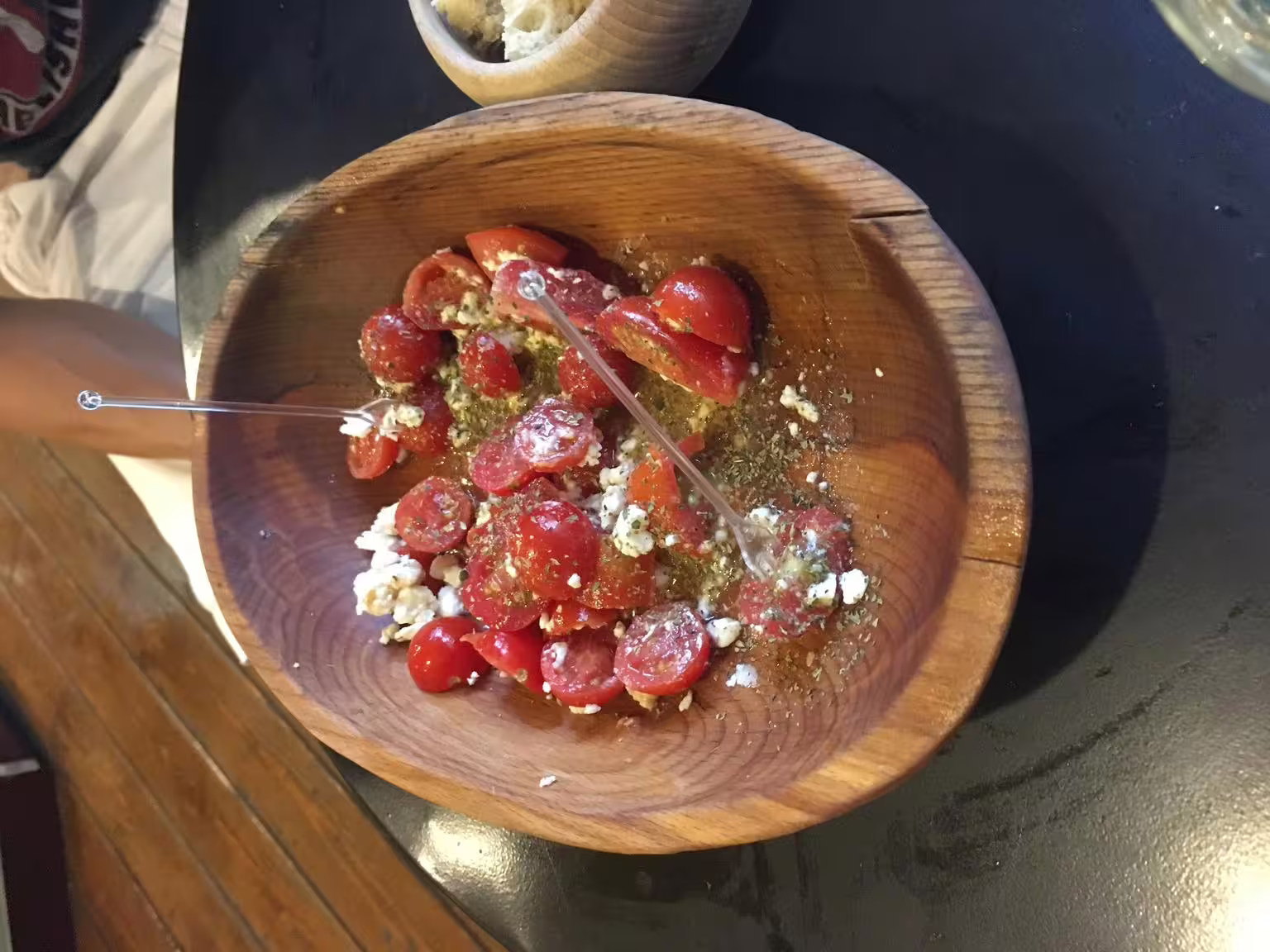 Greek tomato and feta salad in a wooden bowl, a classic tasting on a gourmet food walking tour in Athens