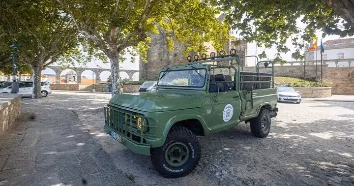 Green 4x4 safari vehicle parked by Porto city walls, North Coast Adventure tour for nature, history and culture