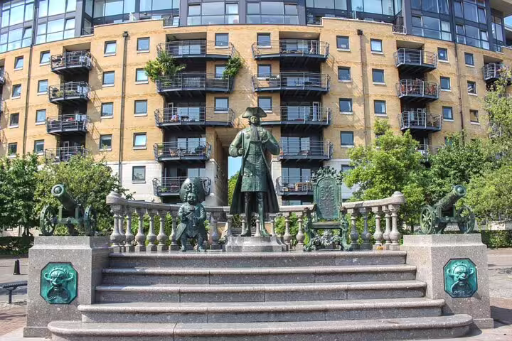 Bronze statue monument with cannons and balustrade steps in Greenwich, London