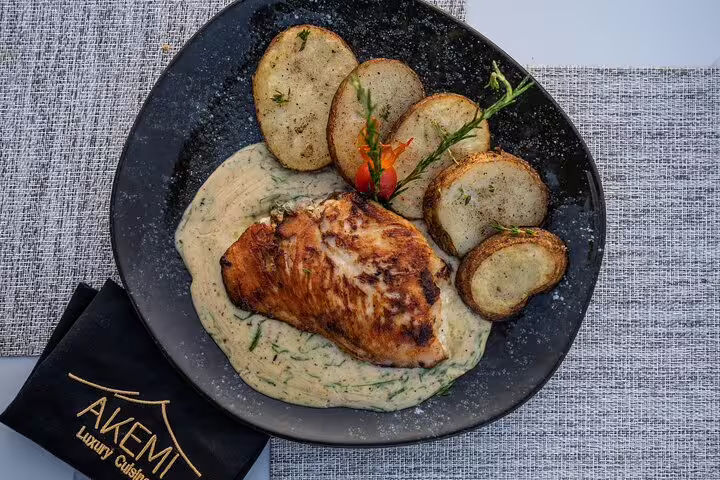 Grilled chicken lunch plate with potatoes and creamy sauce served at Great Pyramid Inn with pyramids view