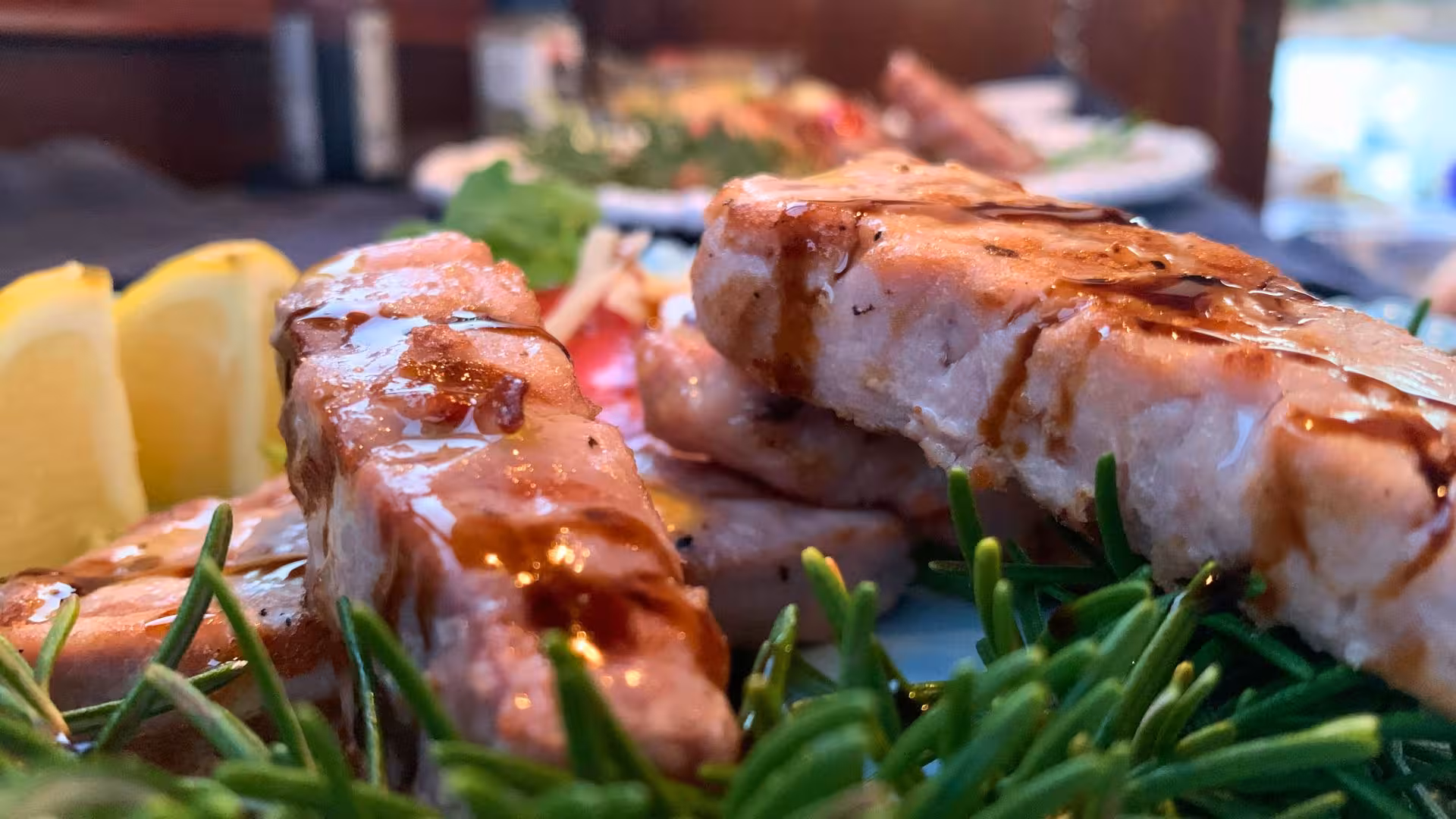 Grilled seafood garnished with rosemary and lemon, highlighting a culinary delight on the La Maddalena sunset tour.