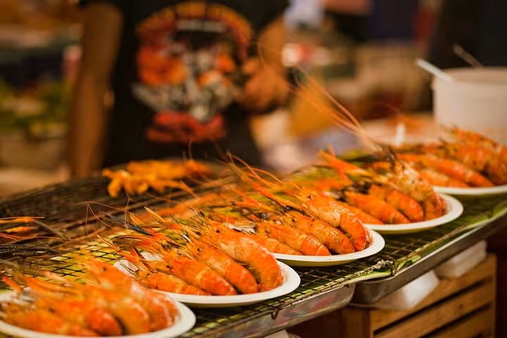 Plates of grilled shrimp arranged on a table at a vibrant seafood cooking class in Rio de Janeiro, Brazil.