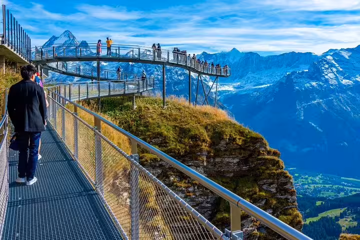 Visitors enjoy breathtaking views from the Grindelwald First Cliff Walk, a highlight of the adventure tour from Zurich.