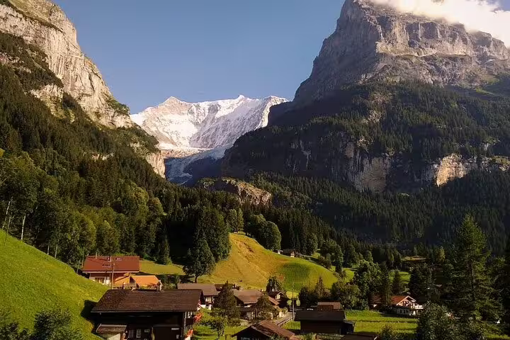 Grindelwald alpine village with snow-capped mountains and green valleys in Swiss Alps