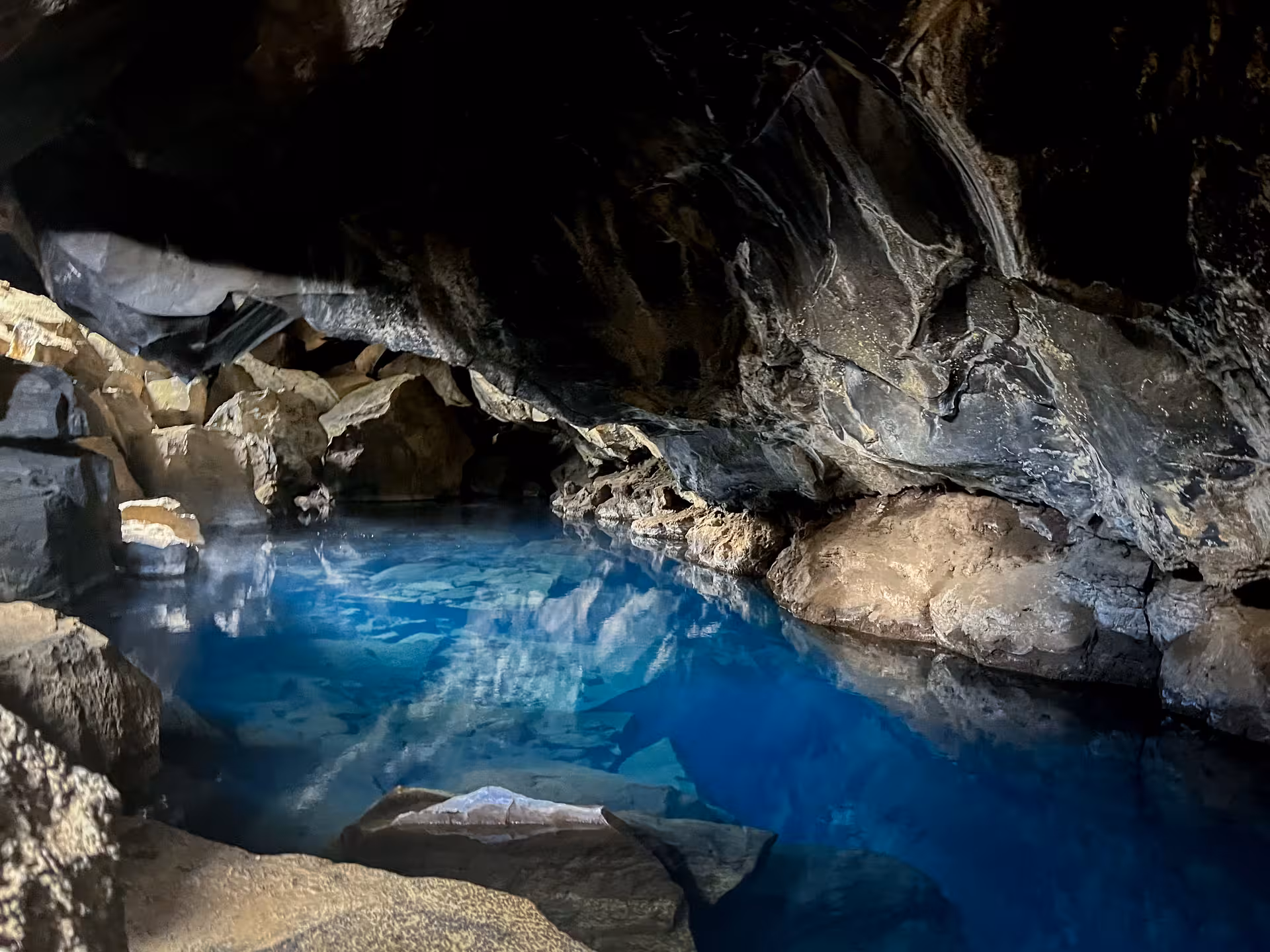 Grjótagjá lava cave with vivid blue geothermal hot spring near Lake Mývatn on Iceland Diamond Circle tour