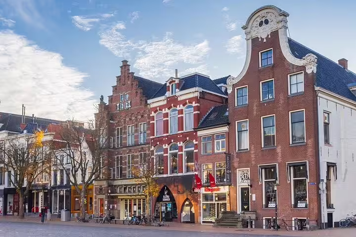 Groningen city center gabled houses and shops on a sunny day, ideal for a self-guided GPS audio tour