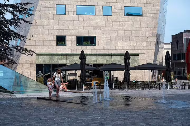 Modern Groningen square with fountains and cafe terraces, featured on the self-guided GPS audio tour