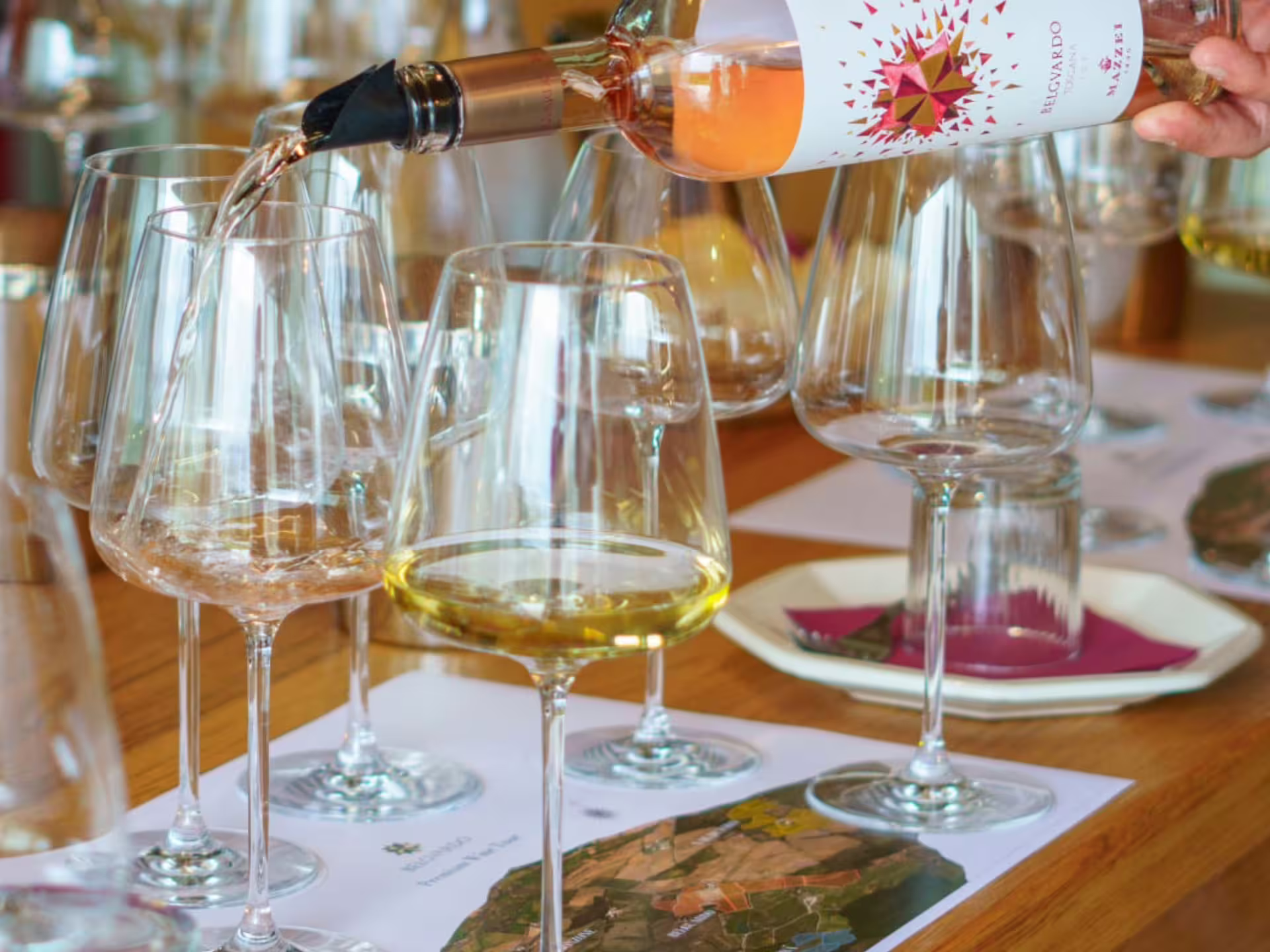 Pouring wine into glasses during a tasting session at a Grosseto winery visit with six exquisite wines.