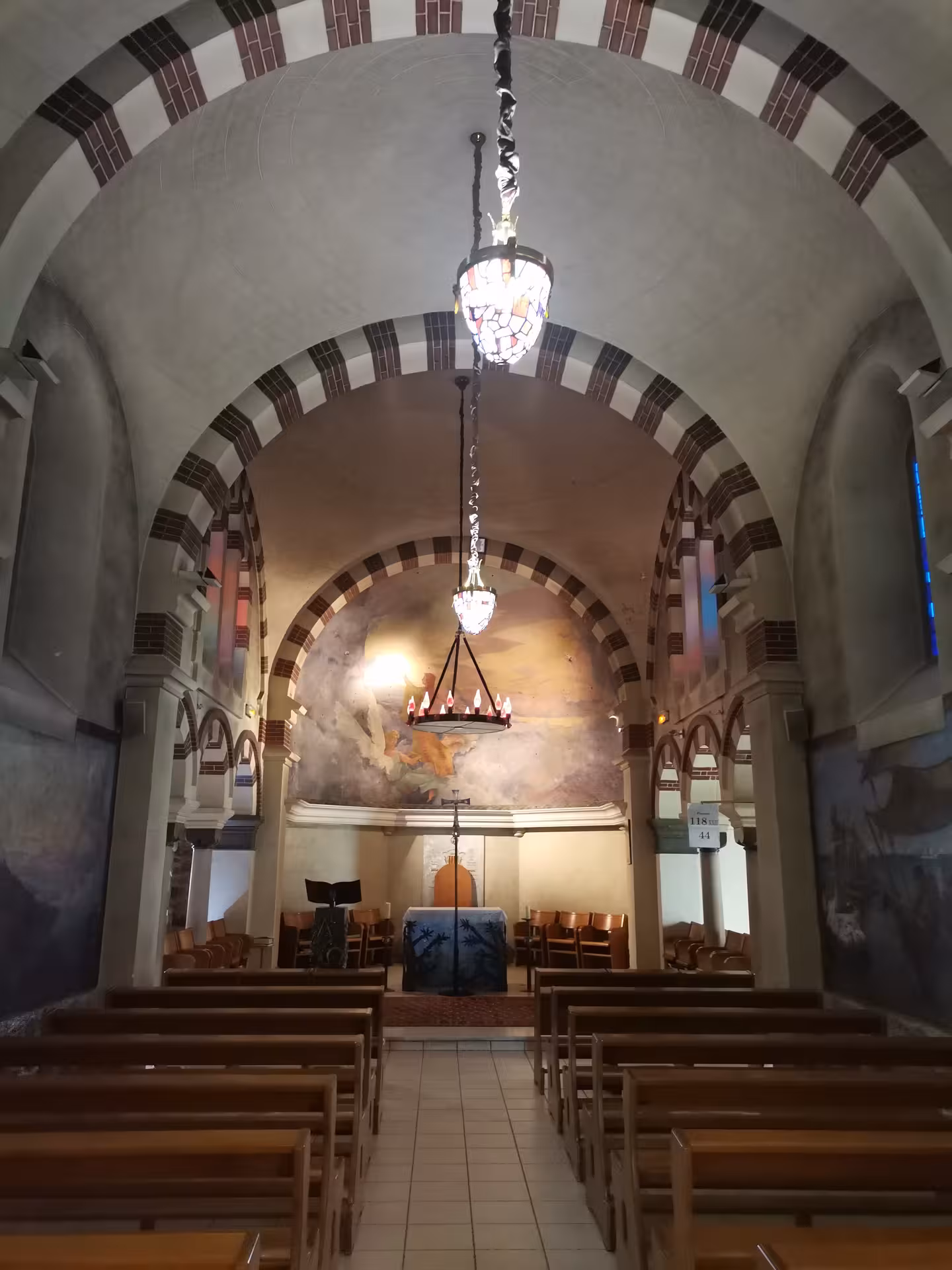 Small chapel interior with arched ceiling and altar, a spiritual stop on the Grotte Sainte-Madeleine hike
