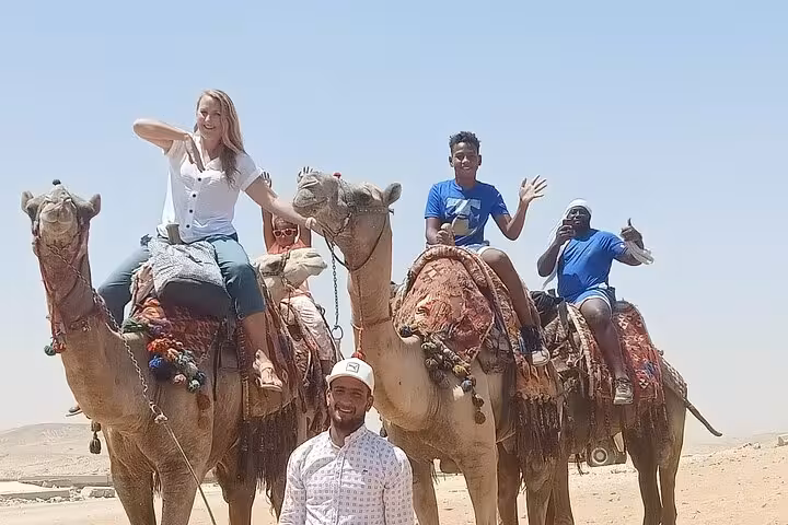 Group camel ride in Giza desert with guide, ideal for private Giza Pyramids & Sphinx tour and quad bike add-on