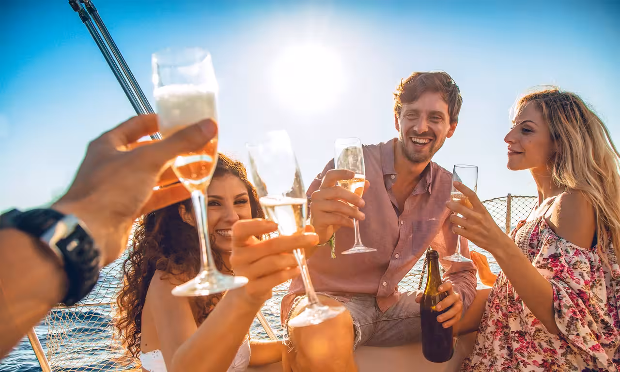 Friends toasting champagne on a sunny boat tour enjoying a relaxing guided cruise in Vilamoura