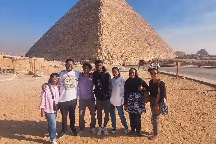 Group photo at the Great Pyramid of Giza during a private Cairo tour with Egyptian Museum and Khan El Khalili