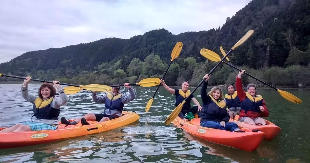 Group kayaking on Furnas Lake, São Miguel Azores, during Mystic Furnas canoeing and bike tour adventure
